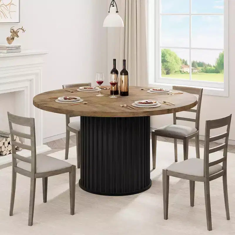 Table à manger ronde avec un piètement en métal ondulé
