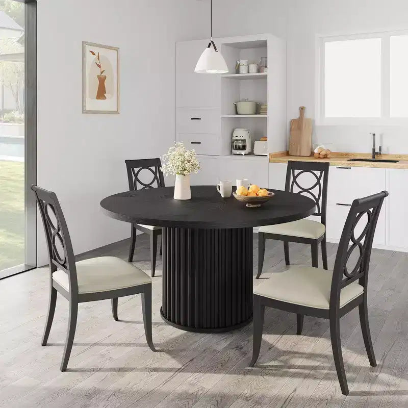 Table à manger ronde avec un piètement en métal ondulé
