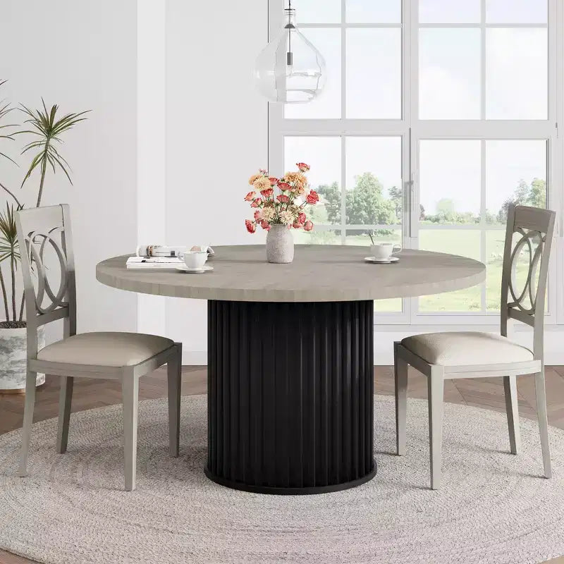 Table à manger ronde avec un piètement en métal ondulé